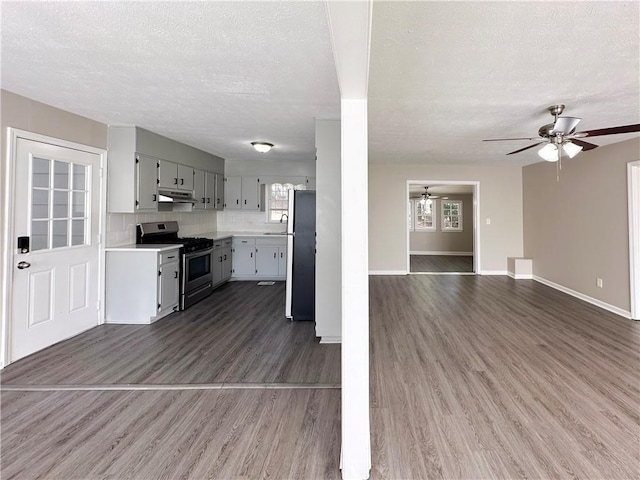 kitchen featuring decorative backsplash, dark wood-type flooring, appliances with stainless steel finishes, and gray cabinets