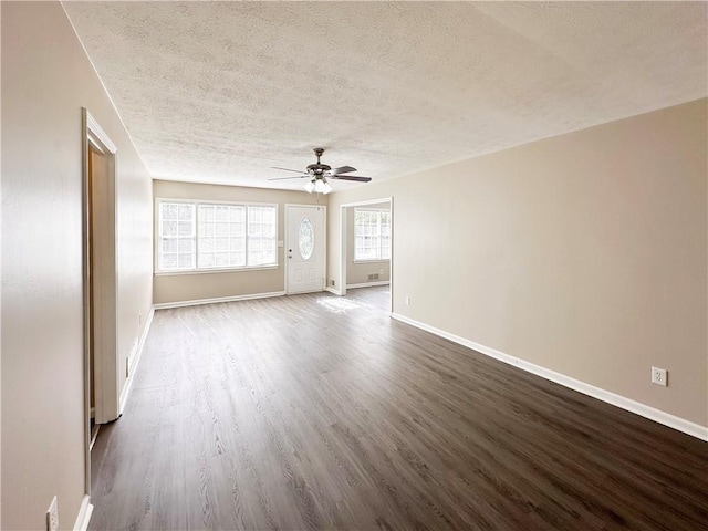 unfurnished room with ceiling fan, wood-type flooring, and a textured ceiling