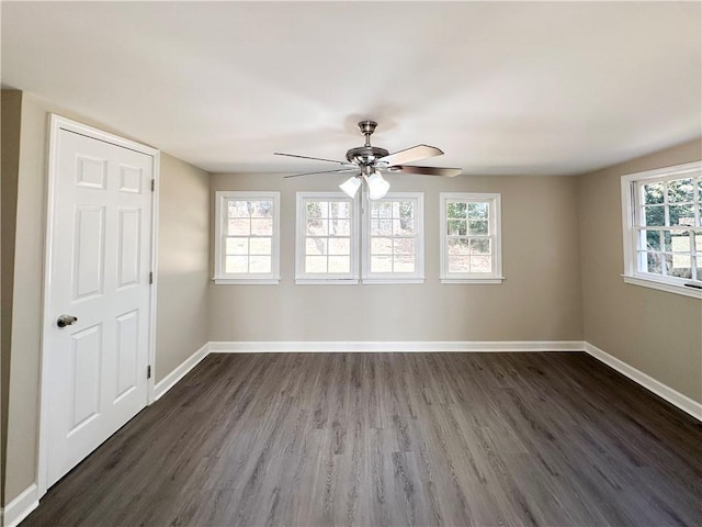 empty room featuring ceiling fan and dark hardwood / wood-style floors