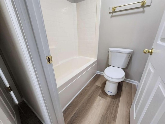 bathroom featuring toilet, hardwood / wood-style flooring, and shower / bath combination