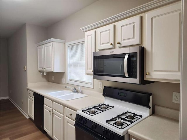 kitchen featuring white cabinets, black dishwasher, sink, and white gas range oven