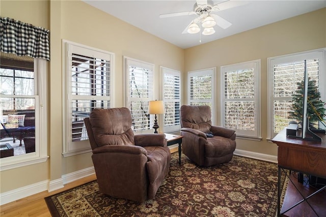 sitting room featuring hardwood / wood-style floors and ceiling fan