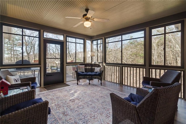 sunroom featuring ceiling fan