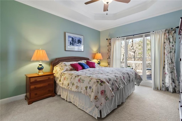 carpeted bedroom with a raised ceiling, ornamental molding, access to exterior, and ceiling fan