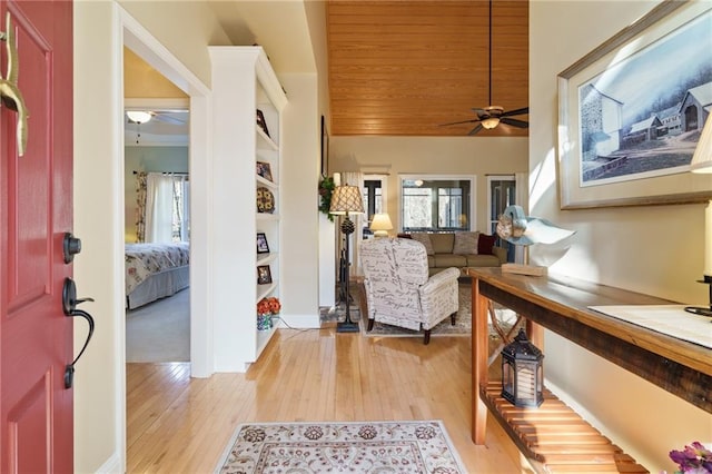 living room featuring wood ceiling, ceiling fan, and light hardwood / wood-style flooring