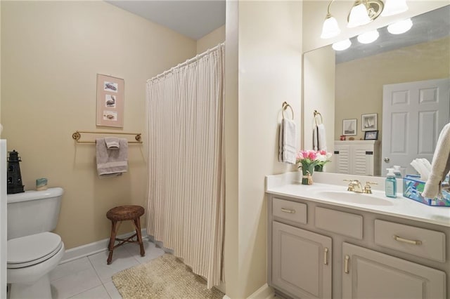 bathroom featuring vanity, tile patterned floors, and toilet