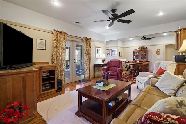 living room with french doors, ceiling fan, and hardwood / wood-style flooring