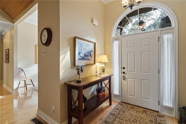 foyer featuring an inviting chandelier and light hardwood / wood-style flooring