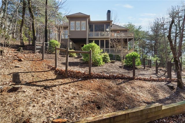 rear view of property with a sunroom