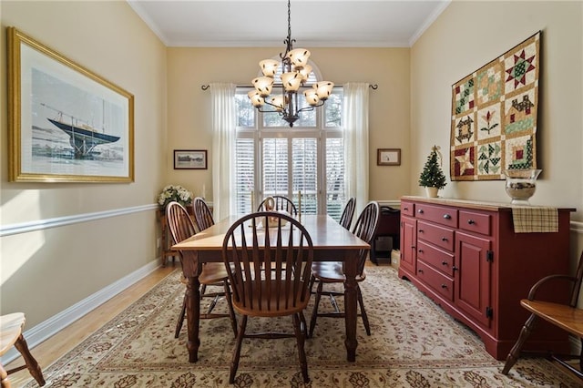 dining space featuring a notable chandelier, light hardwood / wood-style flooring, and ornamental molding