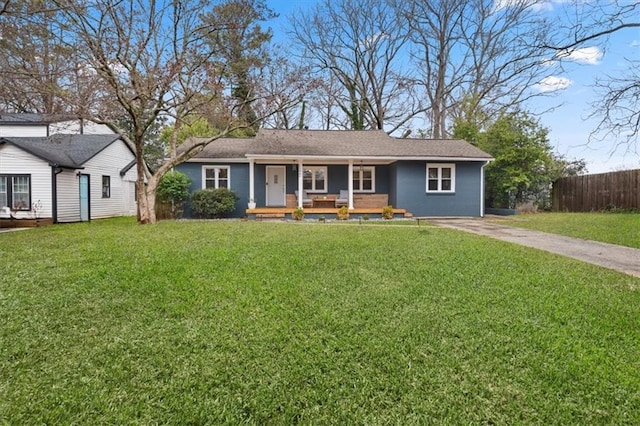 ranch-style home with driveway, fence, a porch, and a front yard