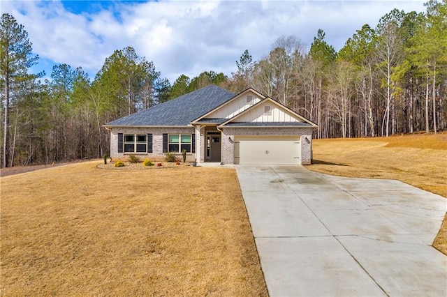 craftsman house with board and batten siding, concrete driveway, a front yard, a garage, and brick siding