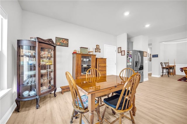 dining space with recessed lighting, light wood-style floors, and baseboards