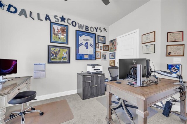 carpeted home office featuring baseboards