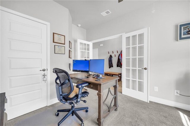 carpeted office space with visible vents and baseboards