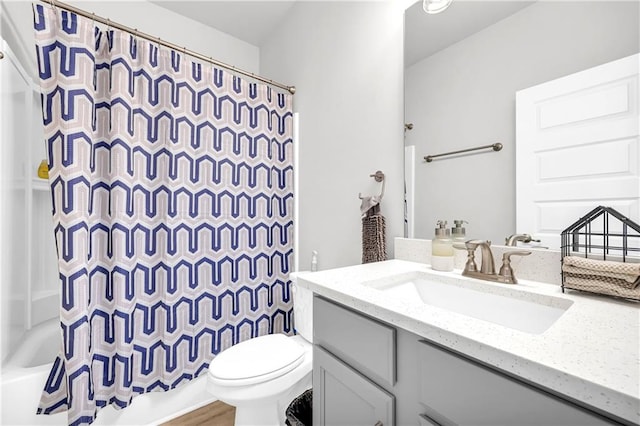 full bathroom featuring toilet, shower / tub combo with curtain, and vanity