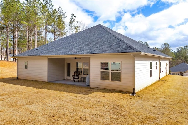 back of house with a yard, ceiling fan, a shingled roof, and a patio