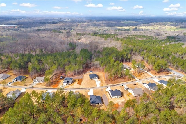 birds eye view of property featuring a view of trees