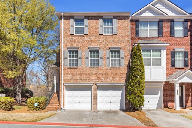 420 Heritage Park Trce NW Unit 22, Kennesaw, GA 30144 - townhome / multi-family property featuring an attached garage, driveway, and brick siding