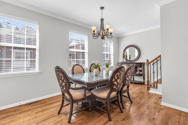 420 Heritage Park Trce NW Unit 22, Kennesaw, GA 30144 - dining room featuring a chandelier, stairs, light wood-style flooring, and ornamental molding