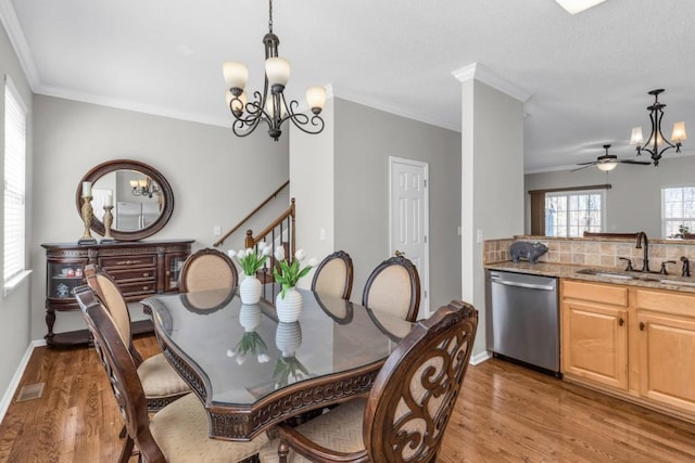 420 Heritage Park Trce NW Unit 22, Kennesaw, GA 30144 - dining area with a chandelier, light wood-style floors, crown molding, stairway, and ceiling fan
