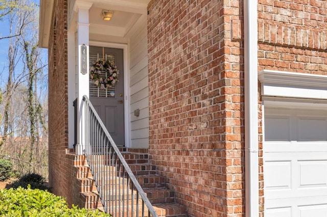 420 Heritage Park Trce NW Unit 22, Kennesaw, GA 30144 - view of exterior entry with a garage and brick siding