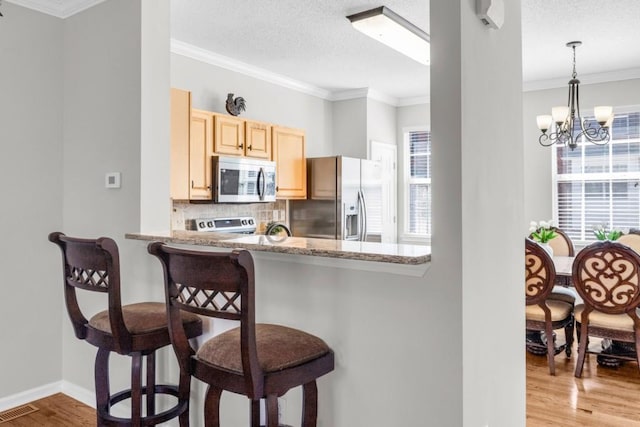 420 Heritage Park Trce NW Unit 22, Kennesaw, GA 30144 - kitchen featuring stainless steel appliances, light brown cabinets, decorative backsplash, a breakfast bar area, and light wood-style floors