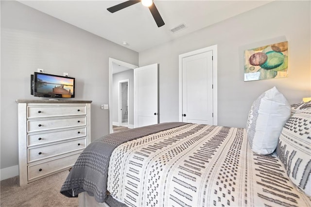 bedroom featuring a ceiling fan, visible vents, light carpet, and baseboards