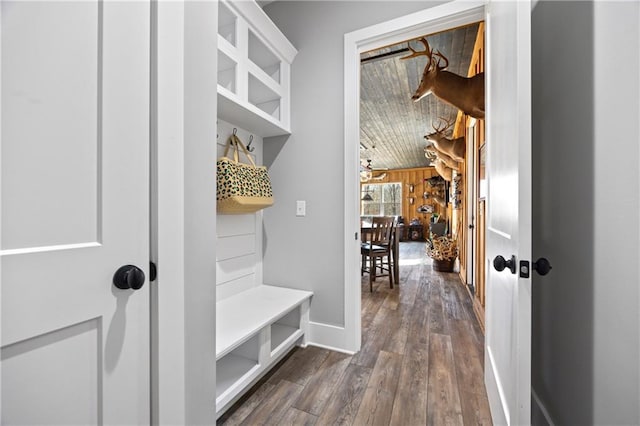 mudroom featuring dark wood finished floors and baseboards