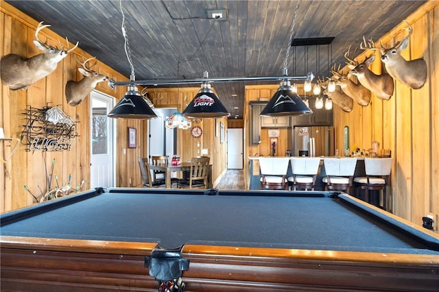 rec room with billiards, wood ceiling, and wooden walls