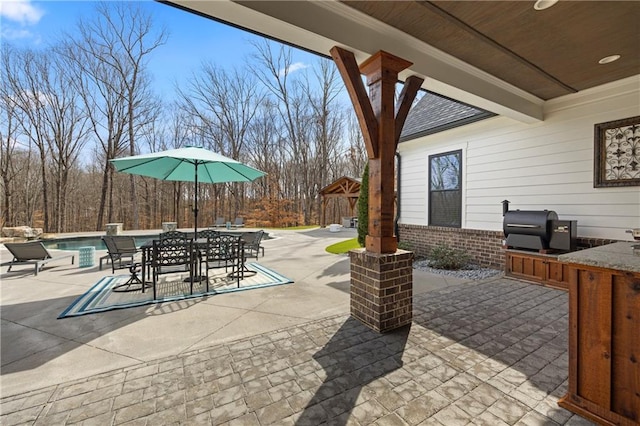 view of patio with a gazebo, area for grilling, and an outdoor pool