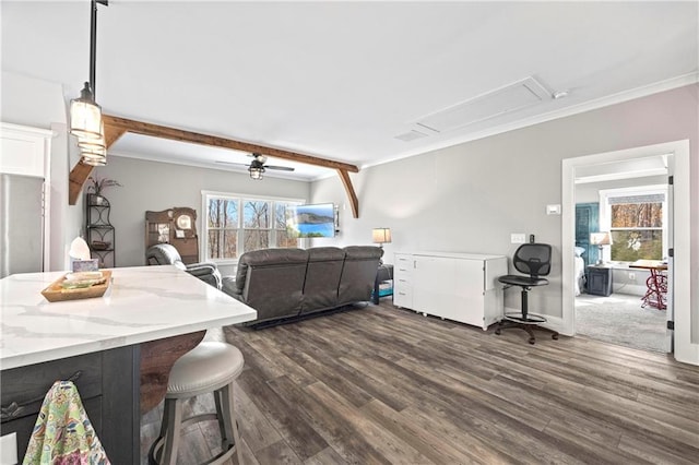 interior space with a breakfast bar, pendant lighting, dark wood-style flooring, a ceiling fan, and open floor plan