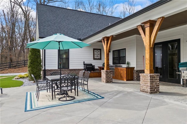 view of patio with fence and outdoor dining space