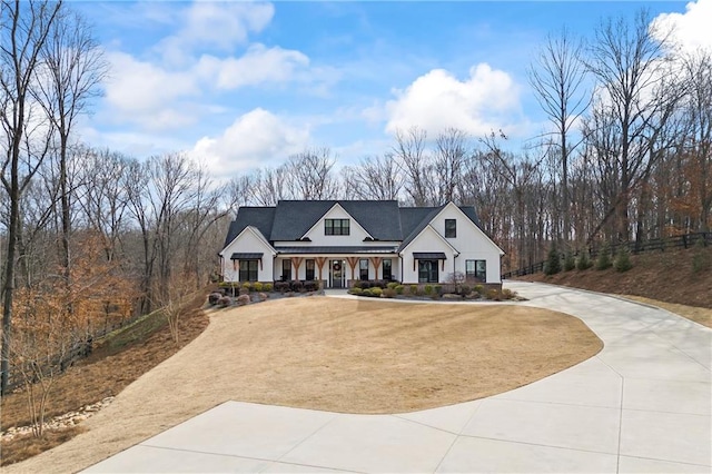 modern farmhouse featuring concrete driveway