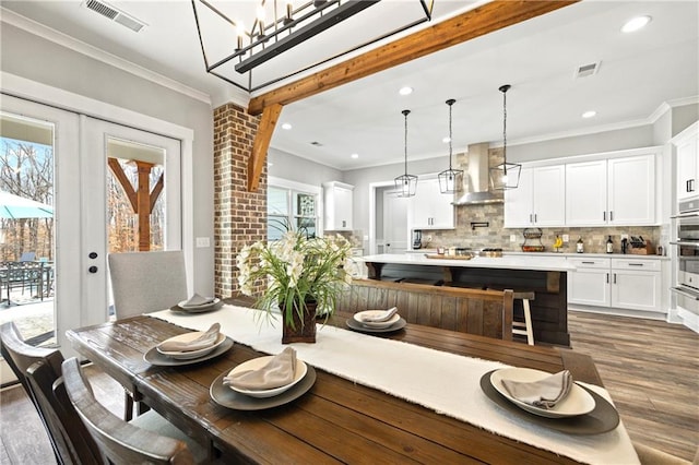 dining space with ornamental molding, french doors, dark wood-style flooring, and visible vents