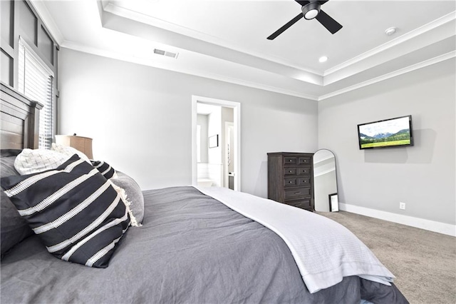 carpeted bedroom with visible vents, baseboards, a ceiling fan, a tray ceiling, and crown molding