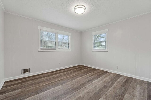 1573 Deerwood Ln, Acworth, GA 30102 - spare room with ornamental molding, a textured ceiling, and dark wood-type flooring