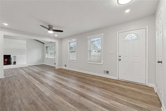 1573 Deerwood Ln, Acworth, GA 30102 - entrance foyer featuring ceiling fan, light hardwood / wood-style floors, and a fireplace