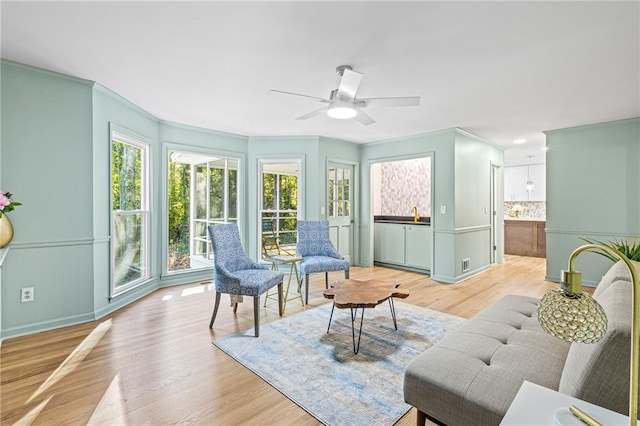 sunroom featuring a ceiling fan