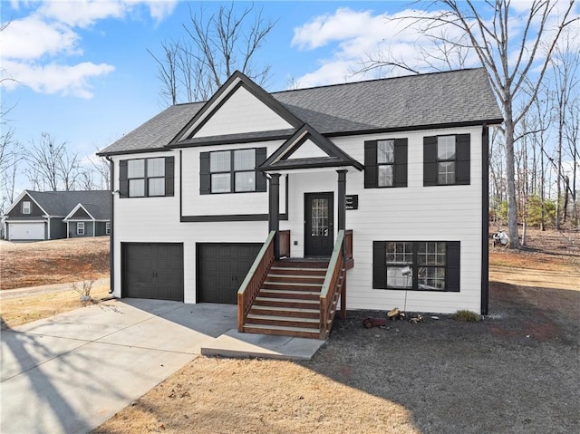 bi-level home with an attached garage, concrete driveway, and roof with shingles