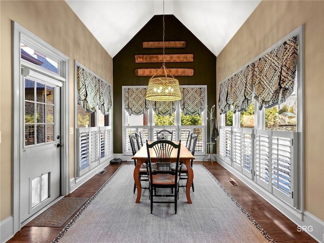 sunroom featuring a chandelier, lofted ceiling, and visible vents