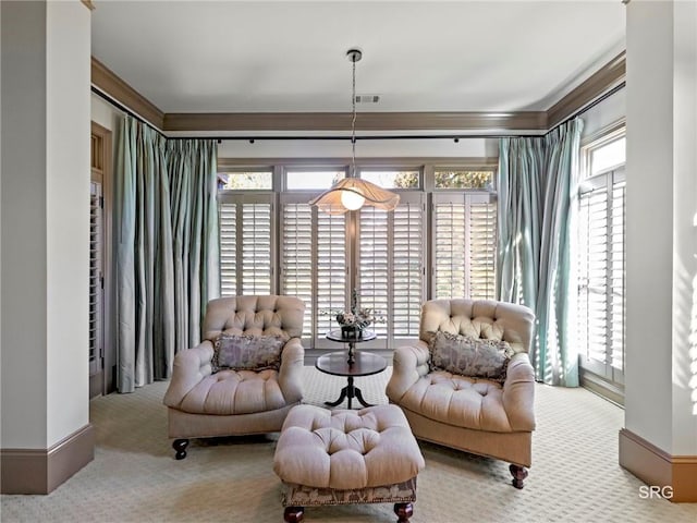 sitting room with plenty of natural light, carpet, and ornamental molding