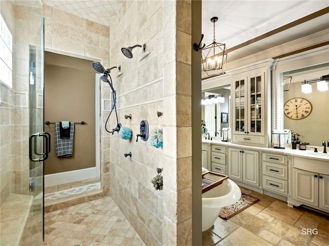 bathroom with a freestanding tub, a sink, a shower stall, double vanity, and stone tile flooring