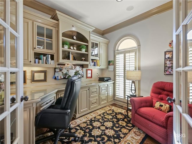 office space with ornamental molding, french doors, and built in desk