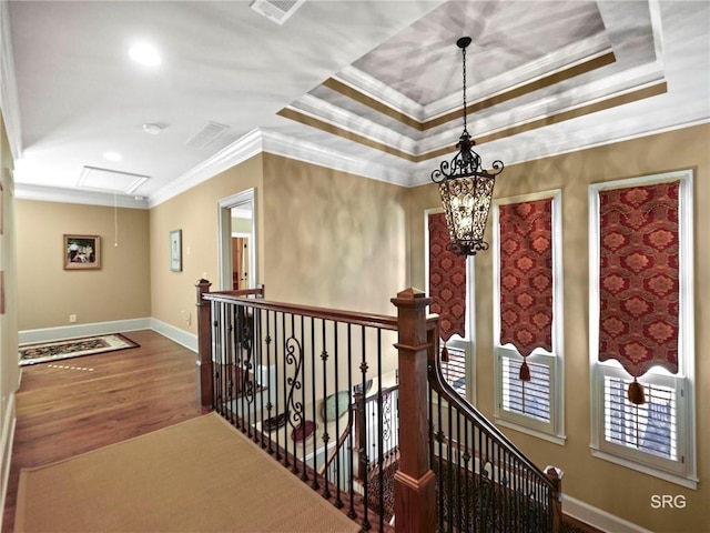 corridor featuring attic access, crown molding, an upstairs landing, and wood finished floors