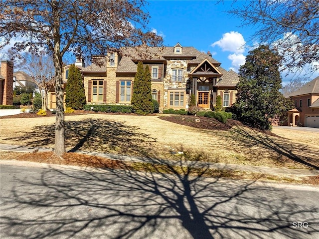 french country inspired facade with a chimney