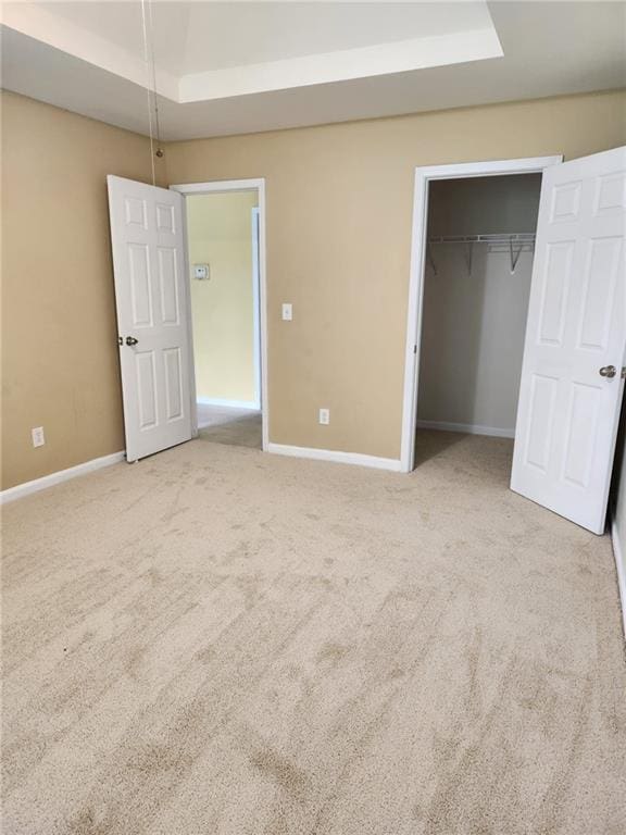 1441 Saint George Pl, Conyers, GA 30012 - unfurnished bedroom featuring a raised ceiling, carpet flooring, and a closet