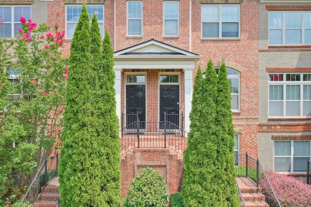 entrance to property featuring brick siding