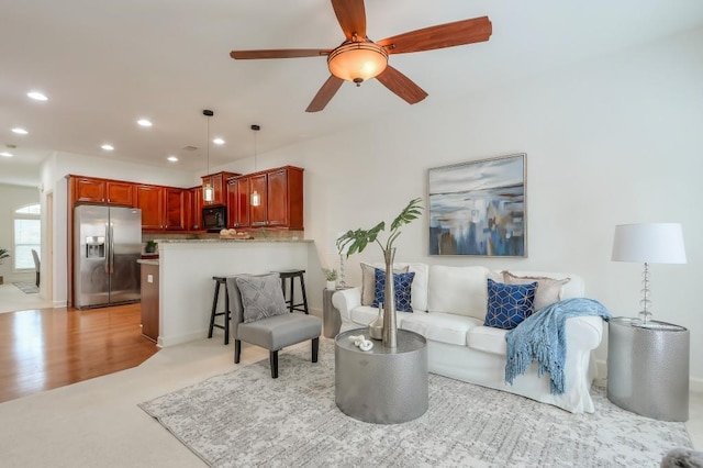 living room featuring a ceiling fan and recessed lighting