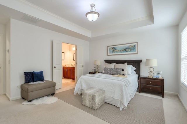 bedroom with baseboards, multiple windows, and a tray ceiling